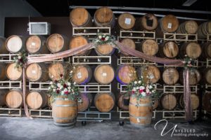 Wedding Ceremony Decor in Front Of Wine Barrels
